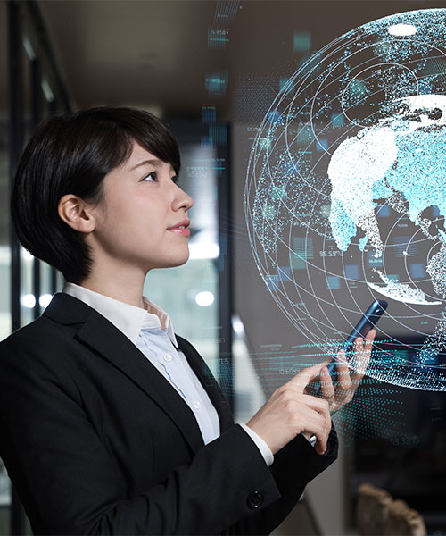 A person looking at a hologram of a globe which shows network connections